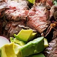 Carne Asada · Sliced tenderloin grilled steak cooked to perfection, served with rice, beans, lettuce & cor...