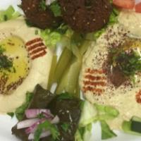 7. Vegetarian Plate · An assortment of stuffed grape leaves, falafel, hummus, and baba ghanouj. Served with pita b...