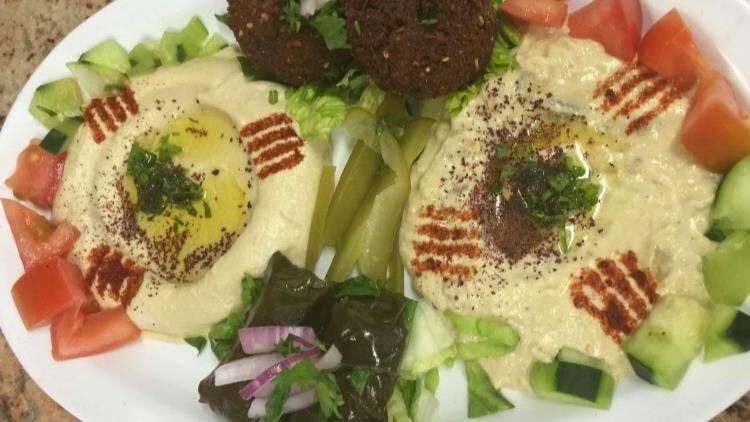 7. Vegetarian Plate · An assortment of stuffed grape leaves, falafel, hummus, and baba ghanouj. Served with pita bread or rice.