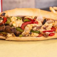 Madd Philly · Peppers, mushrooms, garlic, steak and eggs, sauteed onions and melted cheese.