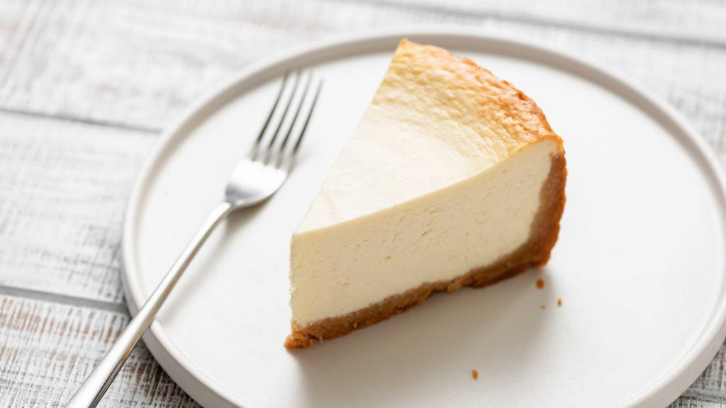 New York Cheesecake · A creamy and rich New York cheesecake sitting on a graham cracker base.