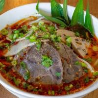 Spicy Hue · Favorite item. Thick rice noodles, spicy beef broth, sliced beef, peppered pork ham, and fre...