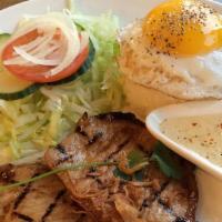 Pork Chop · House marinated grilled pork chop, a sunny side up and crisp veggies. Served with white rice.