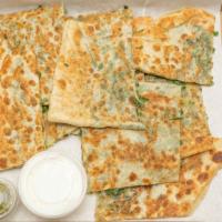 Bolani · Afghan calzone, filled with chopped leeks and/or potatoes, seasoned with special spices, sea...