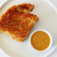 V2. Roti Prata · Multi-layered hand spun Indian bread. Curry sauce