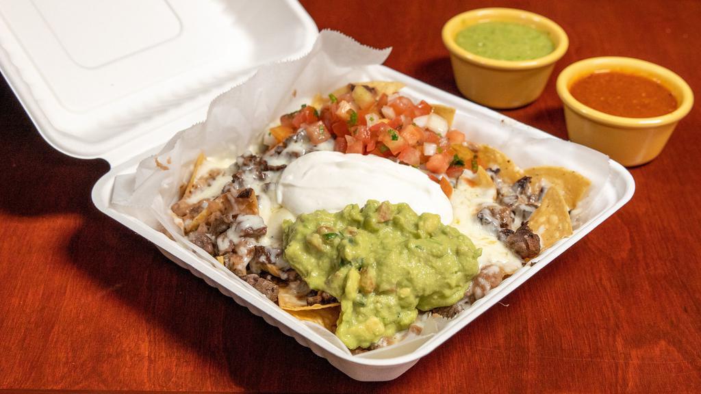 Super Nachos · Corn chips topped with refried beans, melted cheese, fresh salsa, sour cream guacamole and your choice of meat