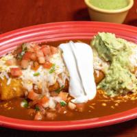 Burrito Mojado · Stuffed with your choice of meat, rice, beans, pico de gallo, topped with enchilada sauce, m...