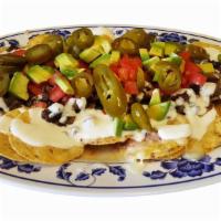 Super Nachos · Choice of meat
Topped with refried beans, melted monterrey cheese , plus sour cream,tomate,f...
