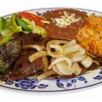 Carne Asada · Delicious grilled steak with grilled onions on top. Served with refried beans,rice and salad.
