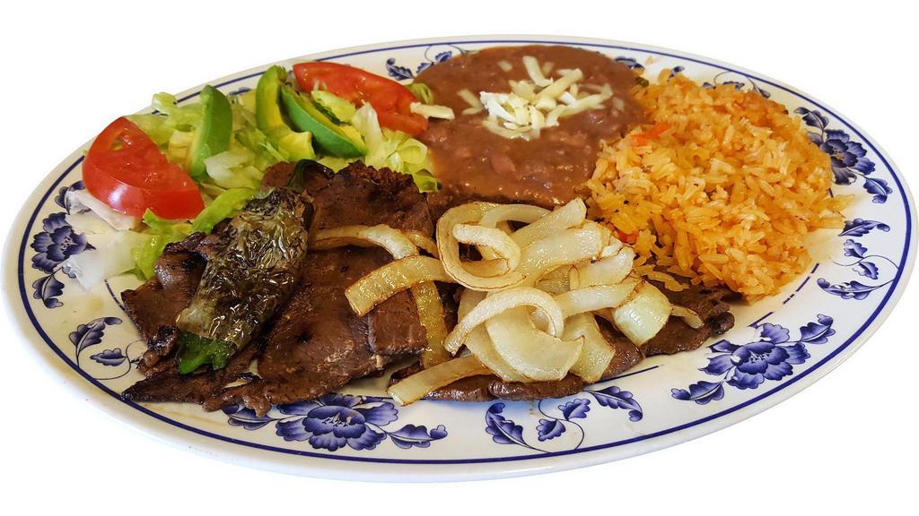 Carne Asada · Delicious grilled steak with grilled onions on top. Served with refried beans,rice and salad.
