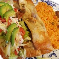 Chimichanga · Fried burrito tortilla  with meat, topped with cheese, lettuce avocado, tomatoes and sour cr...