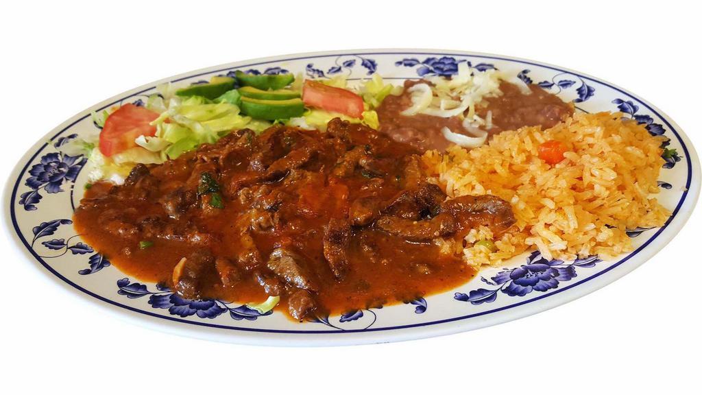 Steak Ranchero · Juicy pieces of steak sauteed in red hot sauce. Served with ,refried beans,rice and salad.