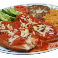 Chiles Rellenos (2) · Breaded bell peppers stuffed with cheese. Served with refried beans,rice and salad on the si...
