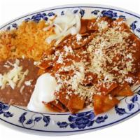 Chilaquiles Rojos(Red) · Fried corn tortilla pieces simmered with our special spicy red sauce topped with  cotija che...