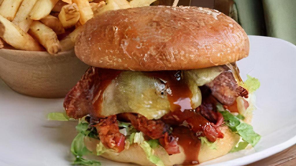 Angus Prime Bacon Cheddar Burger · USDA Prime burger patty, thick cut bacon, white cheddar, DCG secret sauce, house fries.
