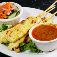 Chicken Satay · Grilled chicken on skewers, marinated with Thai spices and served with peanut sauce and cucu...