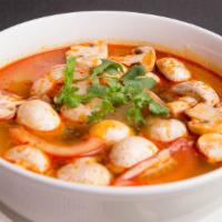Tom Yum Gai (Chicken) · Thai style hot and sour soup with chicken, mushroom, tomatoes, galangal and lemongrass.
