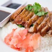 Roasted Duck Over Rice · Boneless roasted duck based with Yao choy, topped with homemade duck sauce over Thai jasmine...