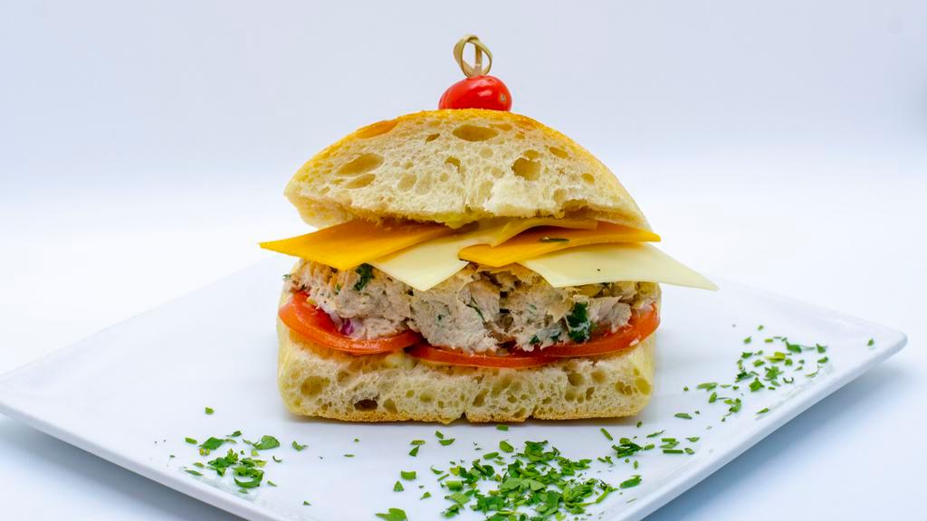 Grand Mama' Tuna Melt · Ciabatta Bread with Grandma' recipe Tuna Salad topped with melted Cheddar and Swiss Cheese and Tomatoes