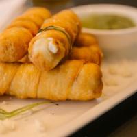 Tequeños with Guasacaca Sauce · Venezuelan dish consisting of a fried breaded cheese with Guasacaca sauce on the side
