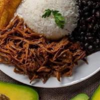 Pabellon Criollo · Traditional Venezuelan  dish -  Shredded beef with white rice , black beans and sweet ripe p...