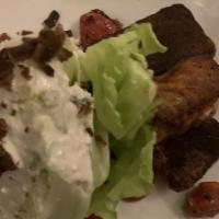 Wedge Salad · Iceberg lettuce wedge, roasted cherry tomatoes, bacon, and blue cheese crumbles with blue ch...