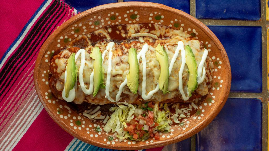 Wet Regular Burrito · Your choice of meat, rice, and beans.  topped with our red mole sauce. (Our red mole sauce contains peanuts).