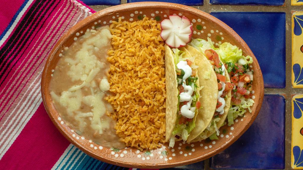 Crispy Taco Plate · 2 hard shelled tacos, your choice of meat, lettuce, sour cream, Pico de Gallo and cheese. With a side of rice and beans.