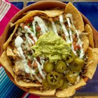 Super Nachos  · Nachos, your choice of meat, nacho or shredded cheese, guacamole, sour cream, jalapenos and ...
