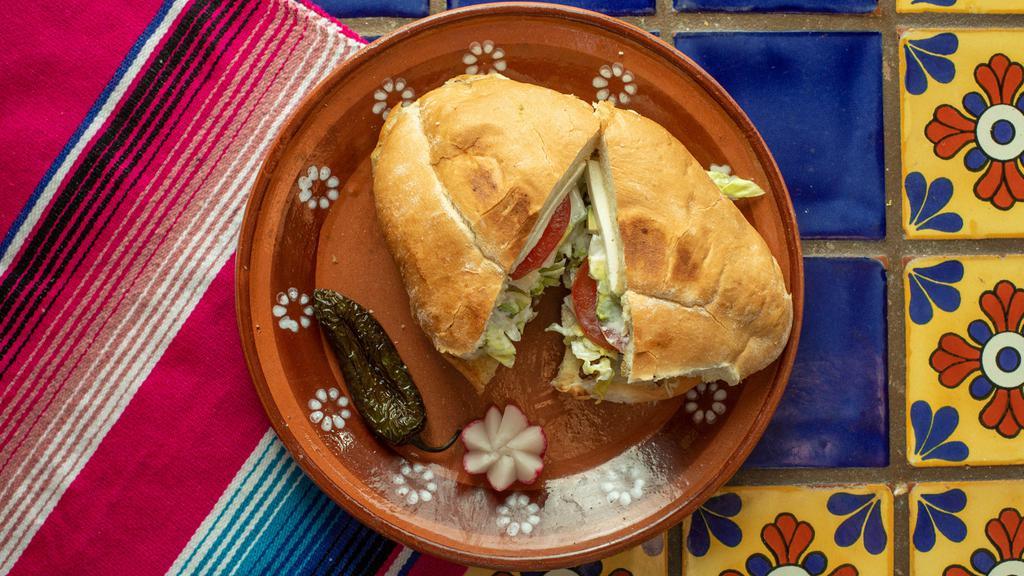 Torta · Mayonnaise, beans, your choice of meat, lettuce, onions, cheese, tomatoes, sour cream and jalapenos,