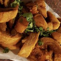Cut Mirchi Bajji · Fresh-cut chilies loosely battered with gram flour, spies, andd deep-fried.