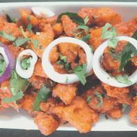 Chicken 65 · Boneless chicken cubes marinated and tossed in spiced yogurt sauce flavored with curry leaves.