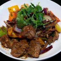 Lamb Pepper Fry · Boneless lamb cubes marinated in special spices, cooked, and pan-fried with peppers and onio...