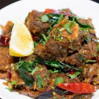 Mutton Roast · Goat cubes marinated in special spices and roaste in a pan with onions and curry leaves.