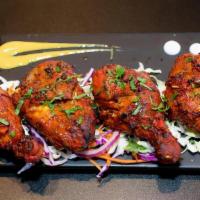 Tandoori Chicken · Whole chicken leg quarter cut into pieces, marinated overnight with a mixture of herbs, and ...