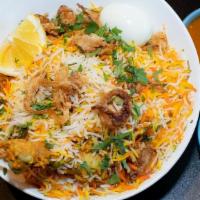 Chicken Dum Biryani - 1/4 Tray · Bone-in chicken marinated and slow-cooked with basmati rice ina tightly sealed vessel. Serve...
