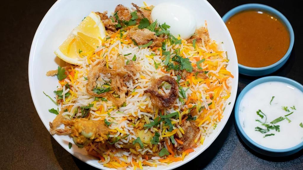 Chicken Dum Biryani · Bone-in chicken marinated and slow-cooked with basmati rice ina tightly sealed vessel. Served with raita and salan.