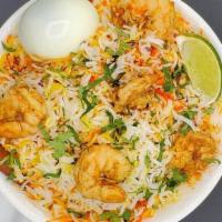 Shrimp Biryani - 1/4 Tray · Peeled and deveined shrimp cooked in a sauce flavored with special spices and mixed with fla...
