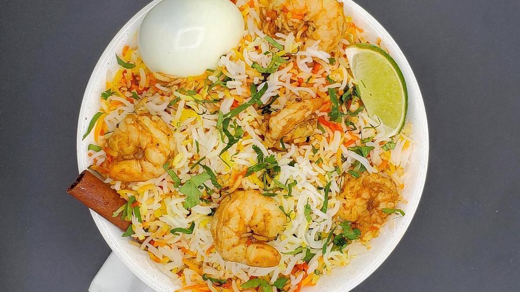 Shrimp Biryani · Peeled and deveined shrimp cooked in a sauce flavored with special spices and mixed with flavored basmati rice. Served with raita and salan.