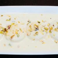 Rasmalai · Soft cottage cheese balls soaked in a rich milk sauce flavored with saffron and pistachio.