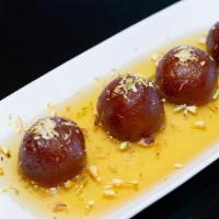 Gulab Jamun · Reduced spongy milk balls soaked in honey and syrup.