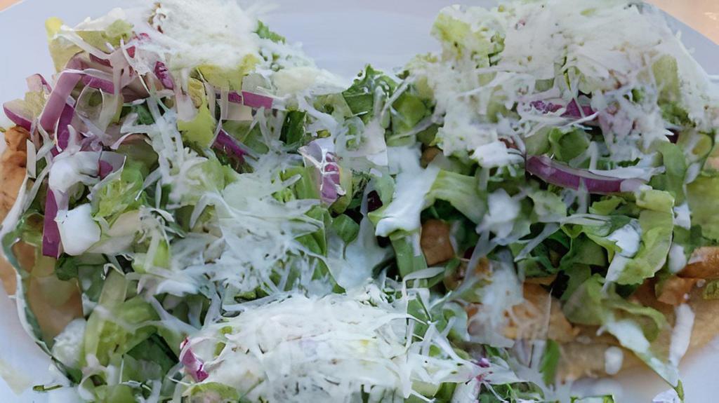 Chicken Caesar Salad · Organic romaine lettuce, parmesan cheese, croutons, and chicken.