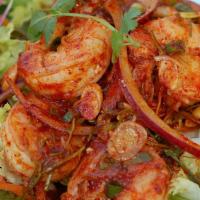 #19. Pla Goong · Grilled shrimp, lemongrass, onions and mint with spicy sauce.