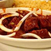 Adobo · Tender chunks of pork sautéed in guajillo and cascabel chile sauce. Garnished with fresh sli...