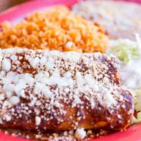 Enchiladas De Mole · Two enchiladas filled with shredded chicken in our famous mole poblano sauce. Topped with ev...