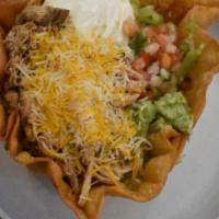 Taco Salad · A giant fried flour tortilla bowl filled with refried beans, shredded cheese, Mexican crema,...