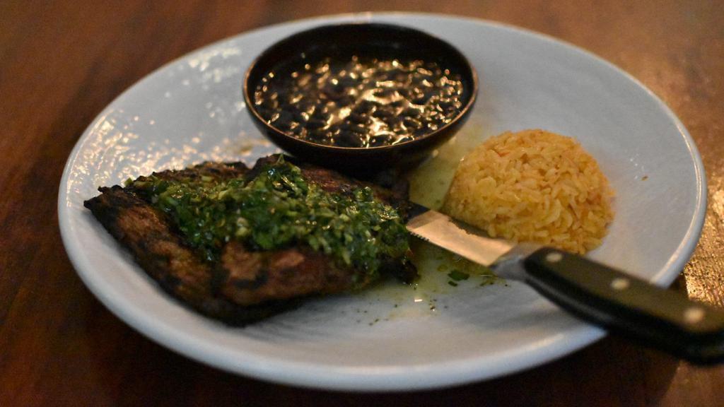 Carne Arrachera · Choice tender steak is specially seasoned flame-broiled and topped with chimichurri sauce. Served with beans, rice and tortillas.
