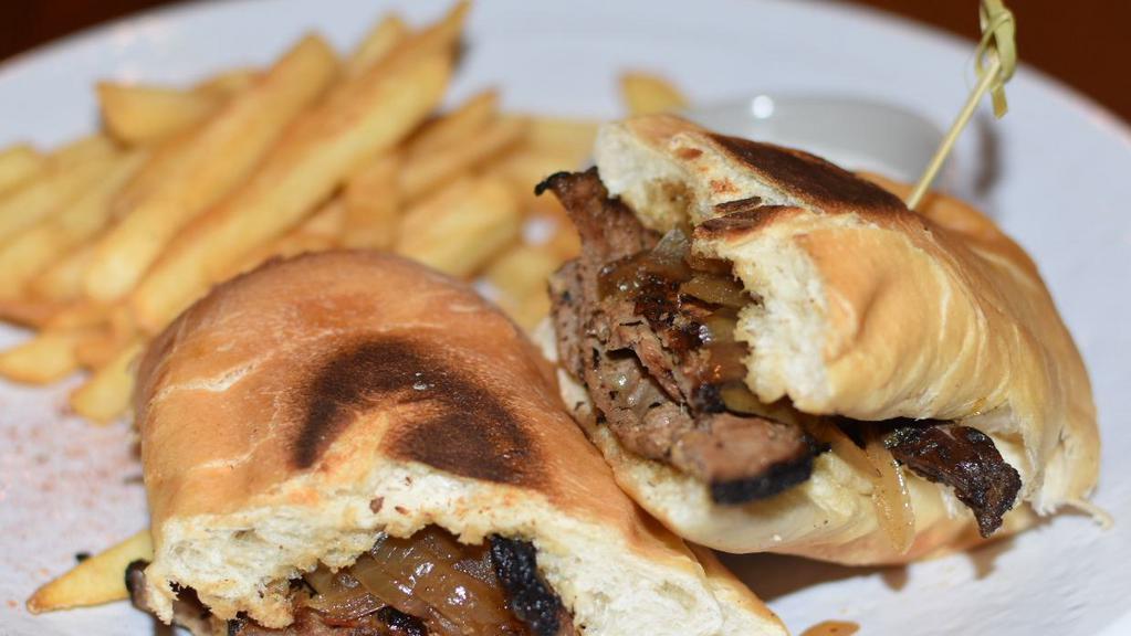 Tri Tip Sandwich · Tri-tip seared over an open fire, sliced thin and topped with caramelized onions on a fresh baked roll. Served with french fries and a side of creamed horseradish.