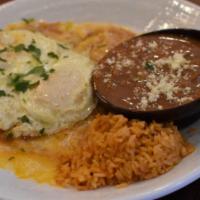 Enchiladas Montadas · Two cheese enchiladas with quajillo enchilada sauce and topped with two eggs. Served with be...