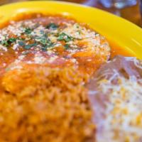 Huevos Rancheros · Three eggs over crispy corn tortillas topped with salsa ranchera, Queso Cotija, and cilantro...